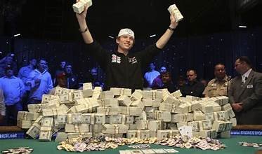 Image of a winning poker player with millions of dollars stacked in front of him.