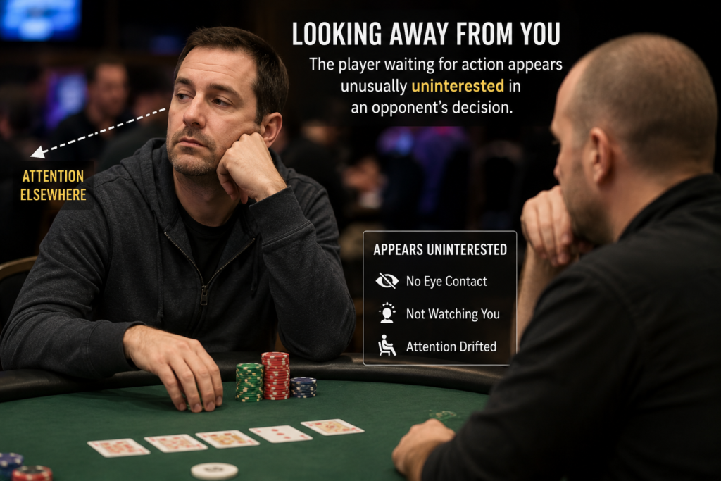Looking Away From You poker tell showing a player waiting for action who appears unusually uninterested in an opponent's decision. The player avoids eye contact and directs attention elsewhere, illustrating a waiting-for-action poker tell that may indicate confidence and strength in live poker.